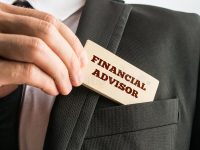 financial-advisor-close-up-hand-businessman-displaying-card-reading-as-removes-pocket-his-jacket-47215394